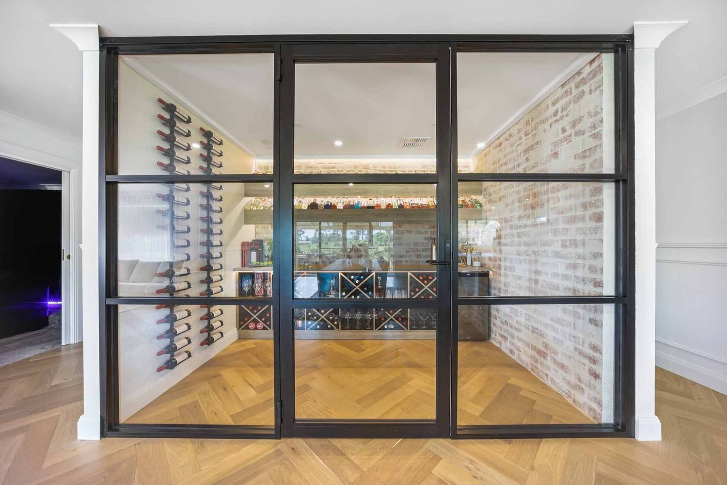 Modern Glass Wine Room With Black-framed Doors — Above & Beyond Interiors in Smeaton Grange, NSW