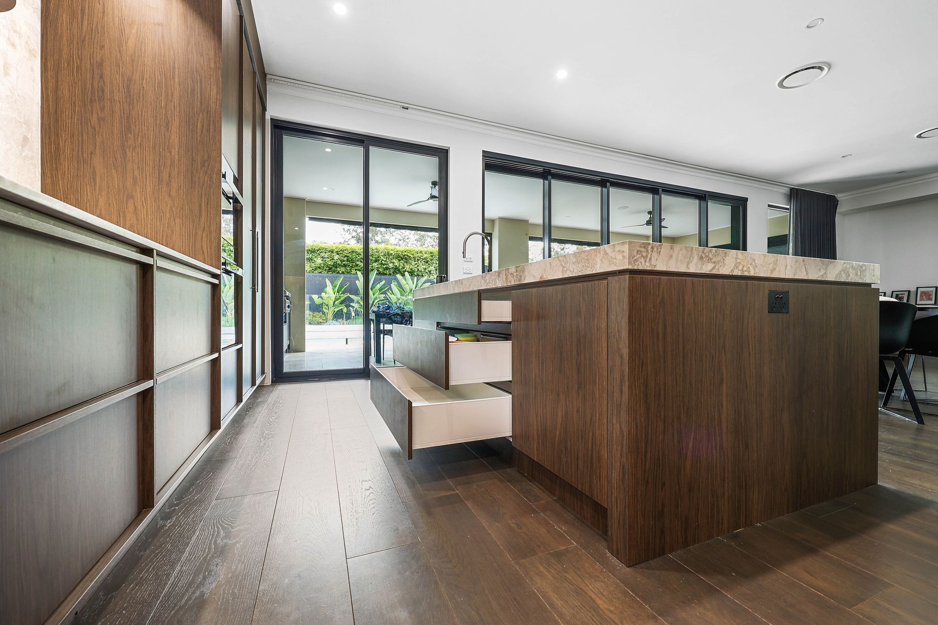 Modern Kitchen Interior With Wood Island, White Cabinetry — Above & Beyond Interiors in Smeaton Grange, NSW