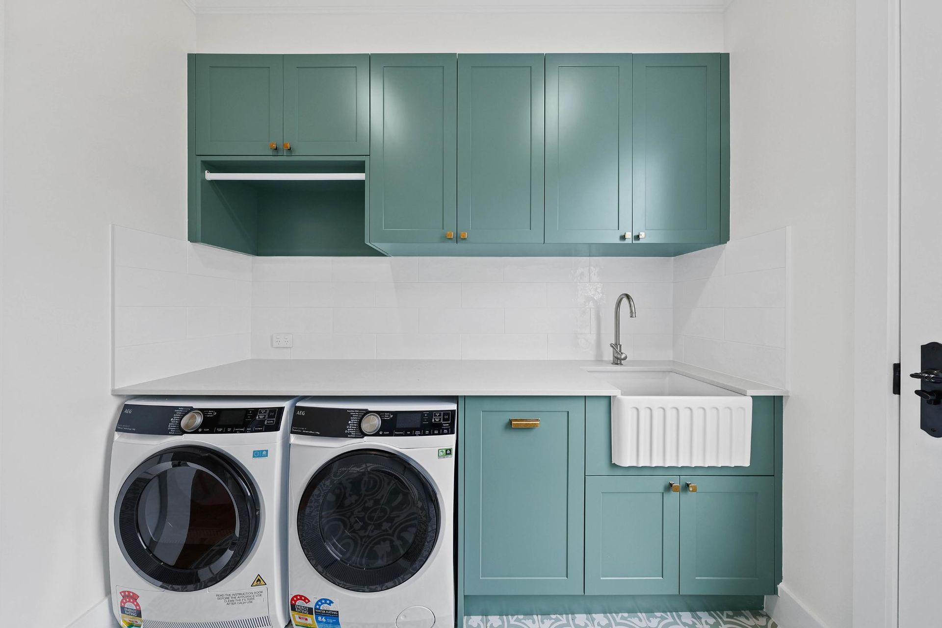 Teal Laundry Room With Washer — Above & Beyond Interiors in Smeaton Grange, NSW
