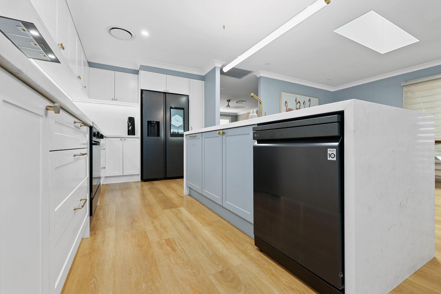 Modern Kitchen With Light Blue Cabinets — Above & Beyond Interiors in Smeaton Grange, NSW