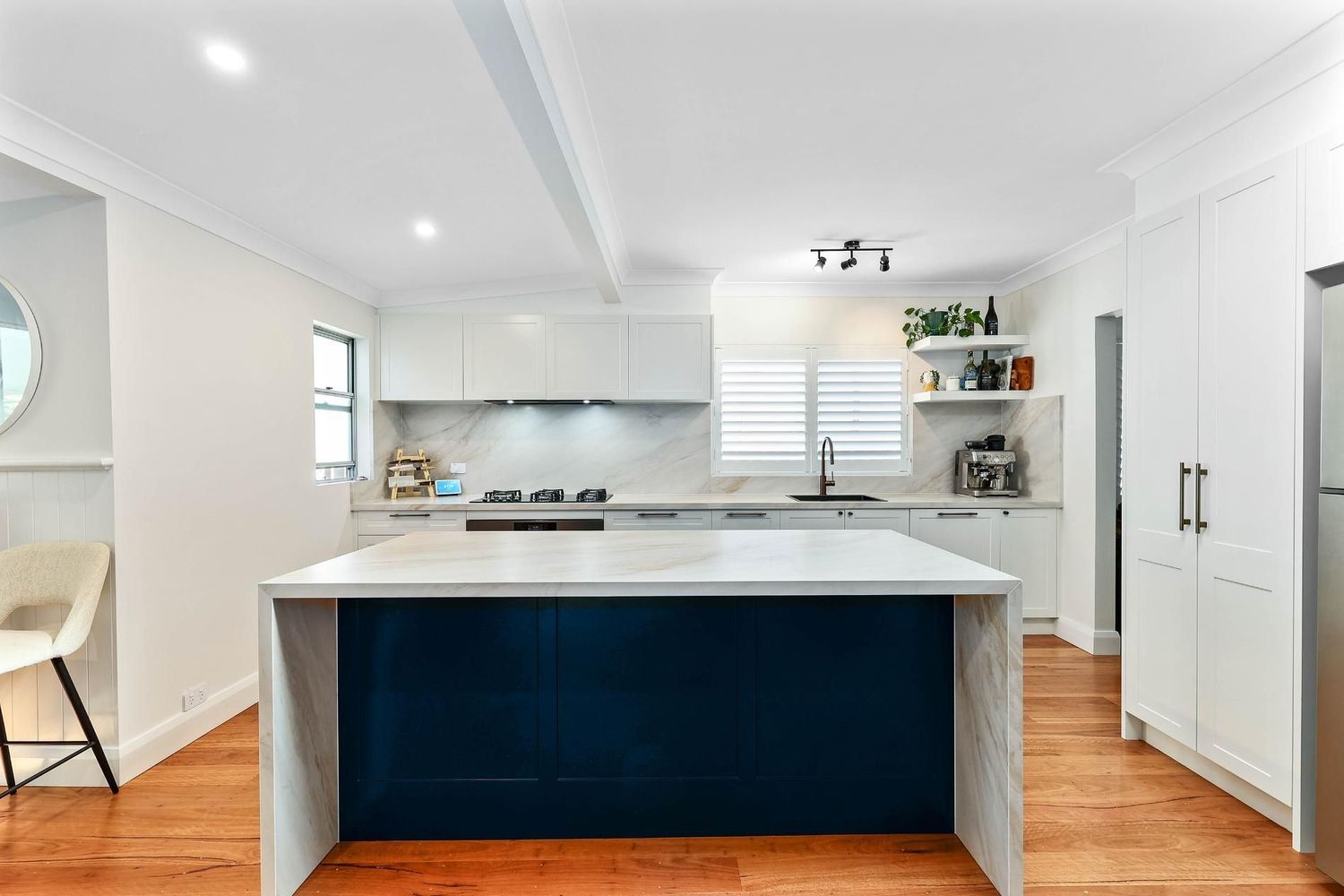 Bright Modern Kitchen With White Cabinets — Above & Beyond Interiors in Smeaton Grange, NSW