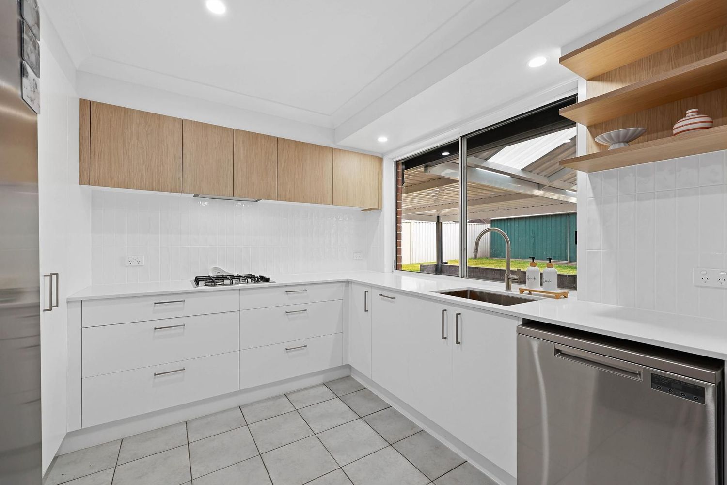 Bright Modern Kitchen With White Cabinets — Above & Beyond Interiors in Smeaton Grange, NSW