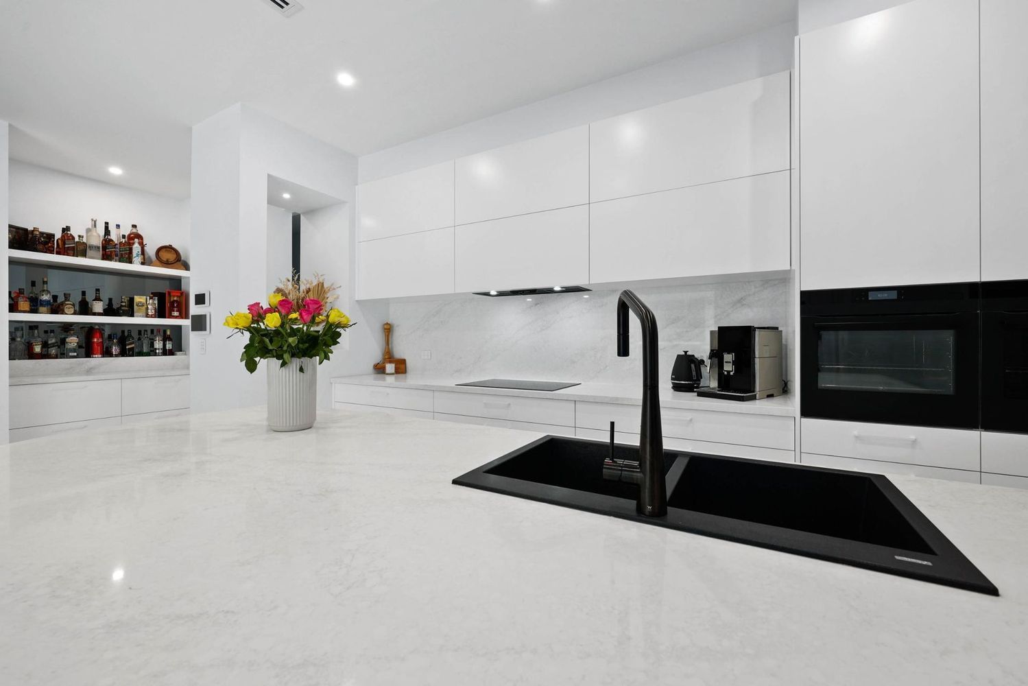 Modern White Kitchen With Black Sink, Built-in Oven — Above & Beyond Interiors in Smeaton Grange, NSW