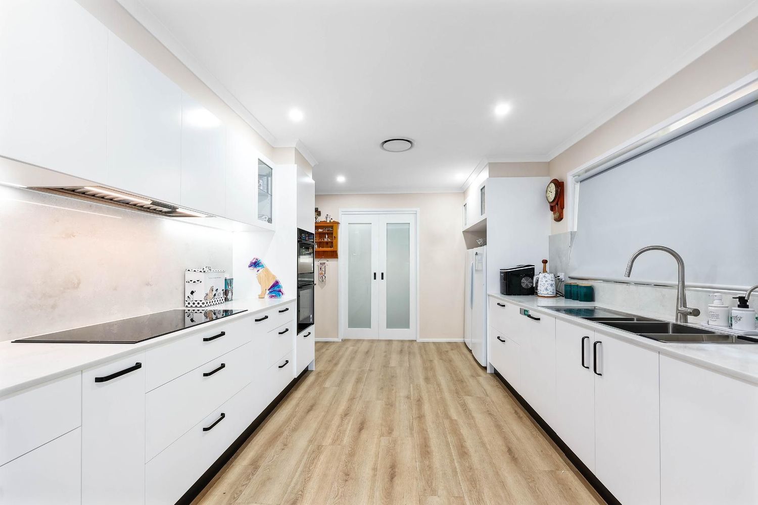 Bright Modern Kitchen With White Cabinets — Above & Beyond Interiors in Smeaton Grange, NSW