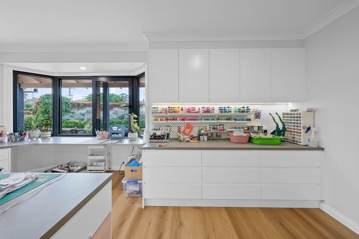 Bright White Nursery With Crib, Changing Table, Toy Shelves — Above & Beyond Interiors in Smeaton Grange, NSW