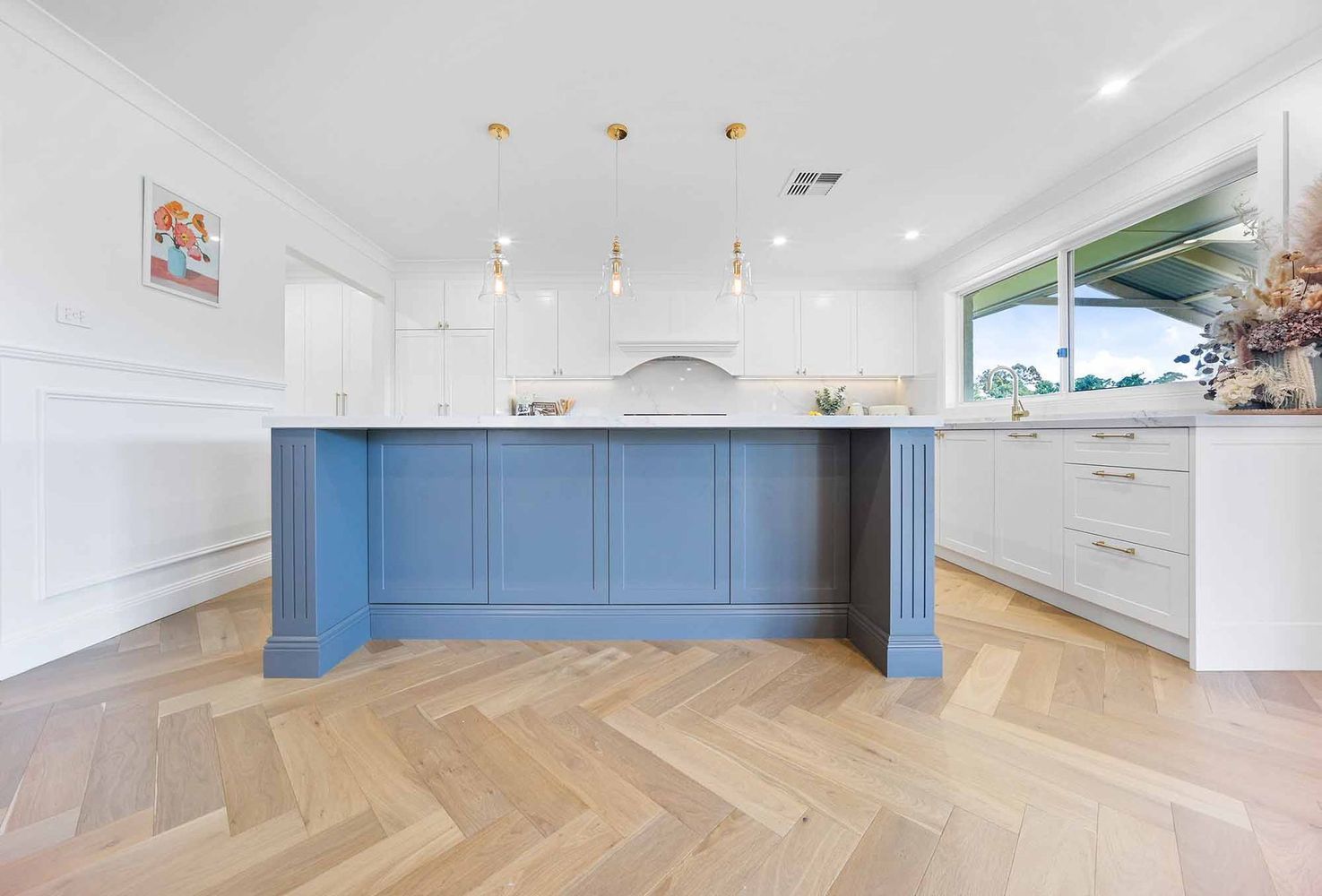 Bright White Kitchen With a Large Blue Island — Above & Beyond Interiors in Smeaton Grange, NSW