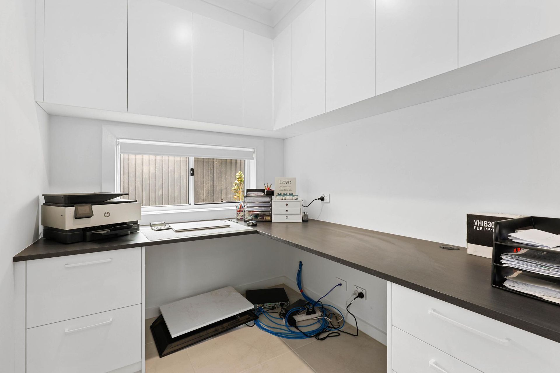 Bright White Laundry Room With Long Counter — Above & Beyond Interiors in Smeaton Grange, NSW