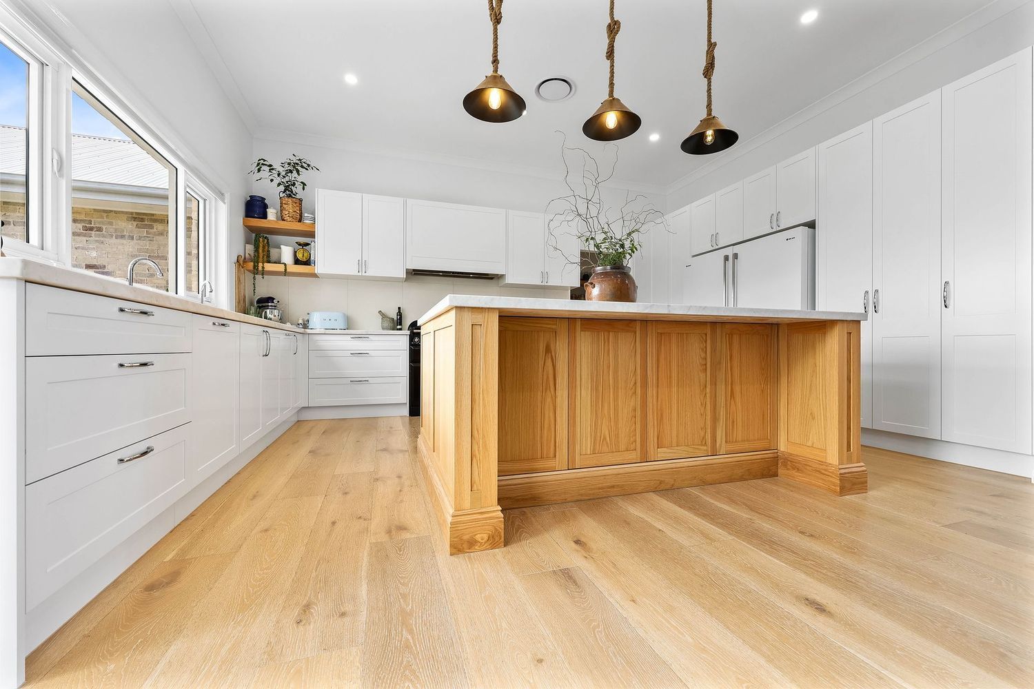 Bright Modern Kitchen With White Cabinets, Wood Island — Above & Beyond Interiors in Smeaton Grange, NSW