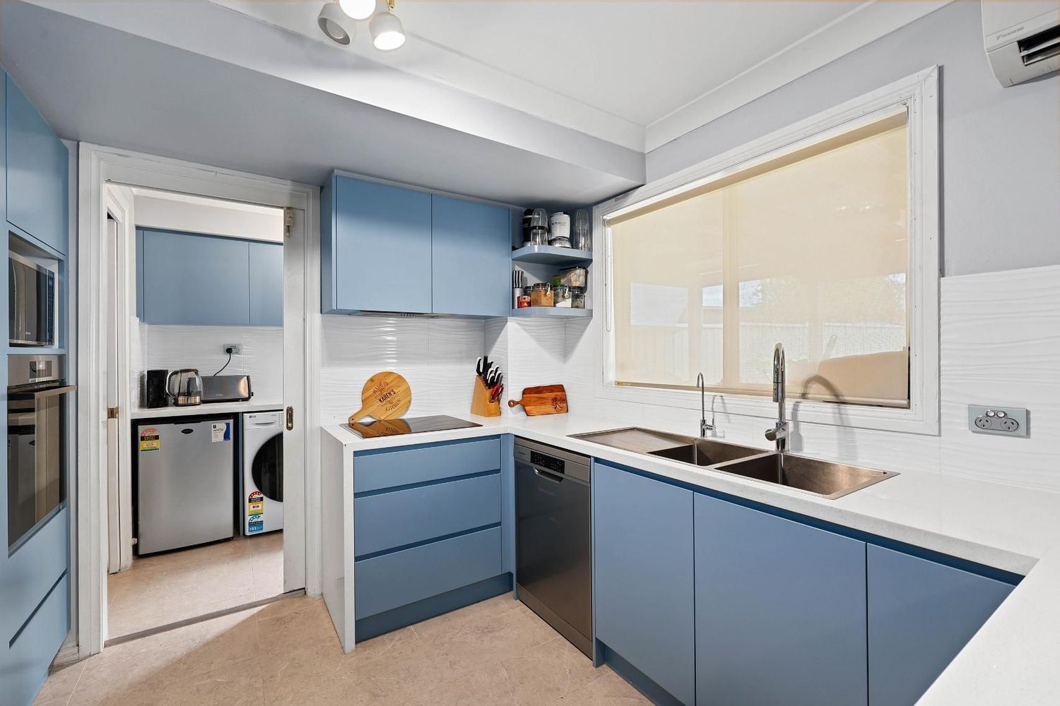 Bright Modern Kitchen With Blue Cabinets — Above & Beyond Interiors in Smeaton Grange, NSW