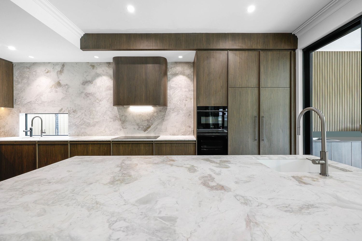 Modern Kitchen With Marble Island, Wood Cabinetry — Above & Beyond Interiors in Smeaton Grange, NSW