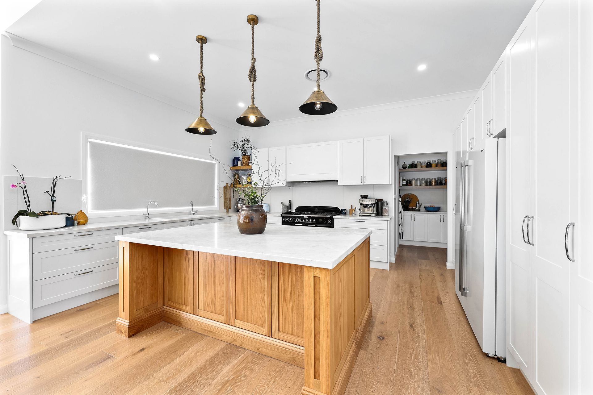 Bright Modern Kitchen With White Cabinets — Above & Beyond Interiors in Smeaton Grange, NSW