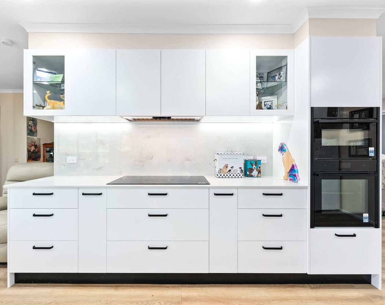 Modern White Kitchen With Built-in Oven — Above & Beyond Interiors in Smeaton Grange, NSW