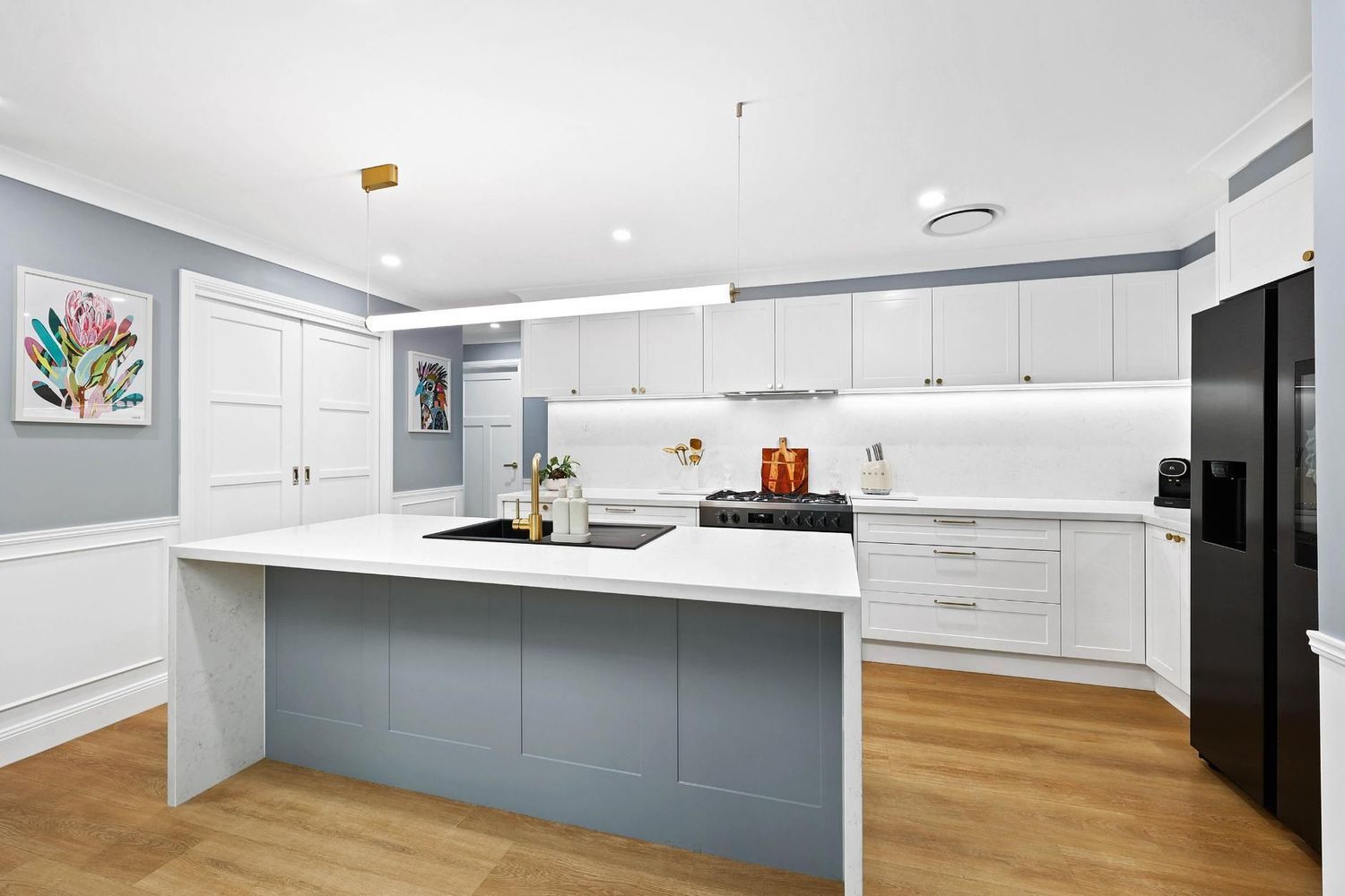 Modern White Kitchen With Large Island, Blue-gray BASE Cabinets — Above & Beyond Interiors in Smeaton Grange, NSW