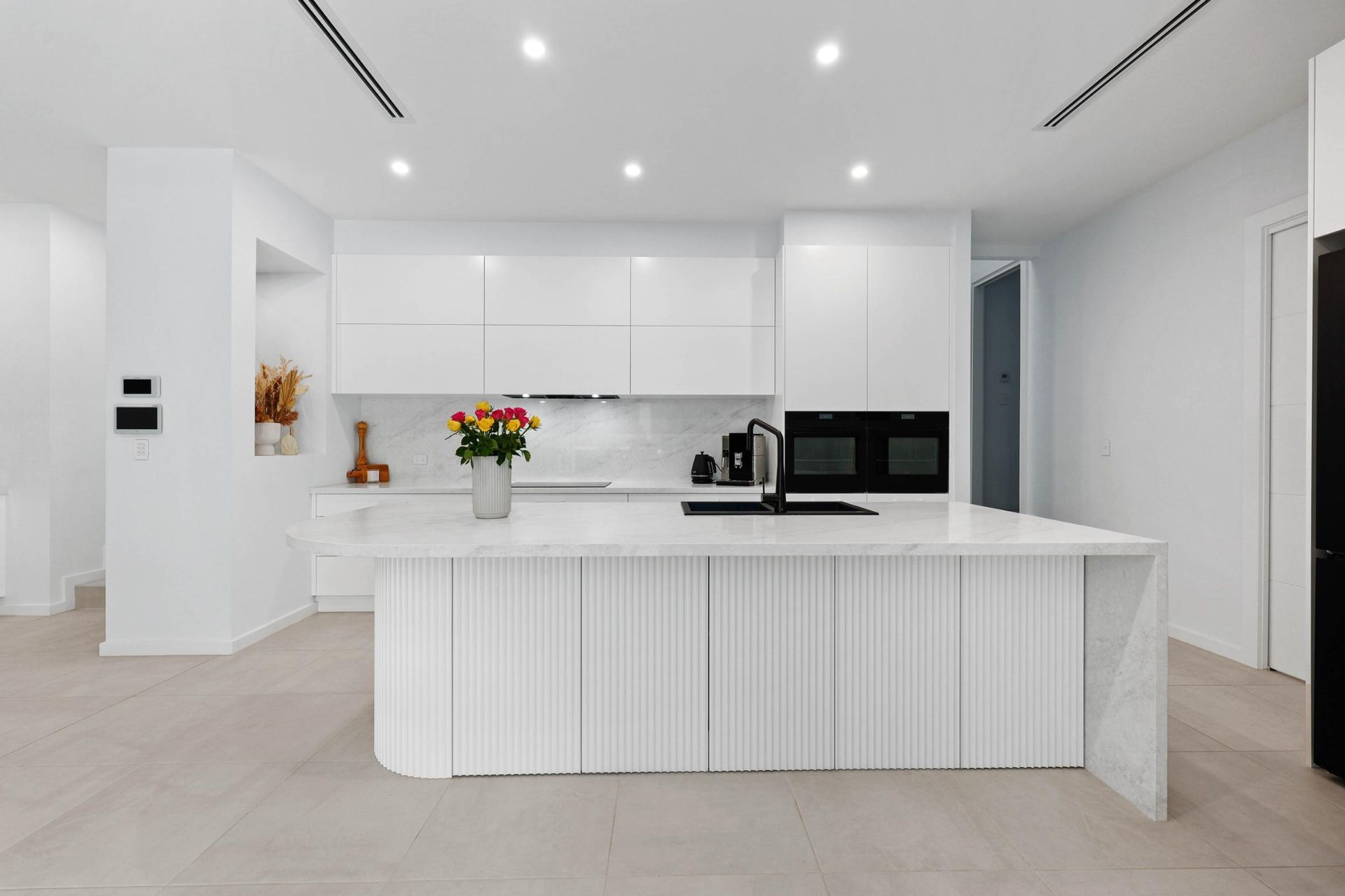 Bright White Modern Kitchen With Island — Above & Beyond Interiors in Smeaton Grange, NSW