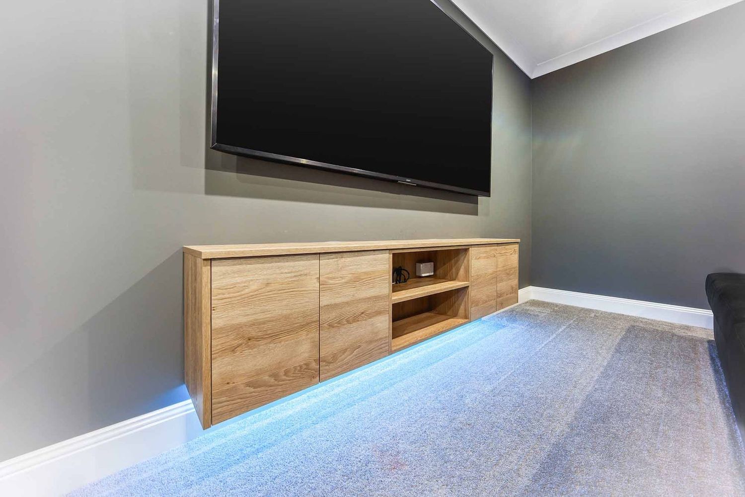 Modern Living Room With Wall-mounted TV — Above & Beyond Interiors in Smeaton Grange, NSW