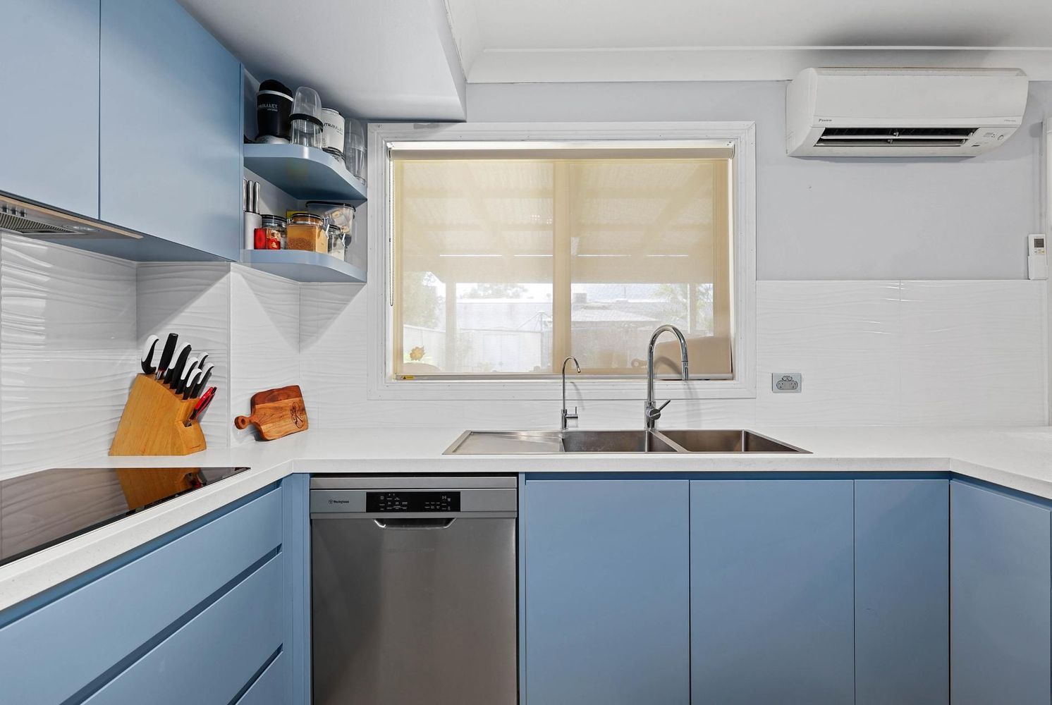 Bright Modern Kitchen With Blue Cabinets — Above & Beyond Interiors in Smeaton Grange, NSW