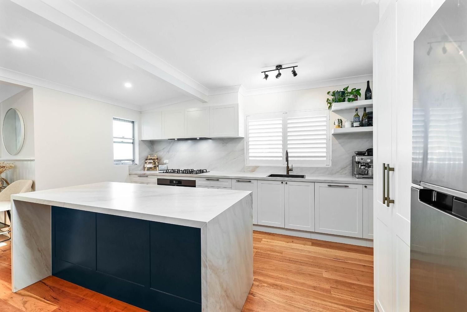 Bright Modern Kitchen With White Cabinets — Above & Beyond Interiors in Smeaton Grange, NSW