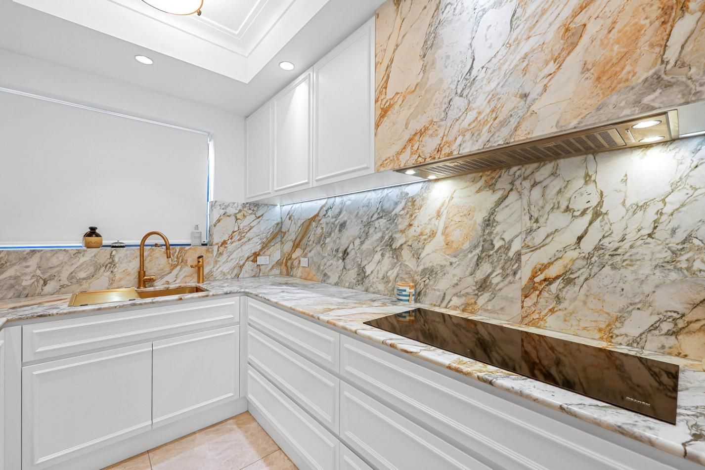 Modern White Kitchen With Marble Countertops and Backsplash — Above & Beyond Interiors in Smeaton Grange, NSW