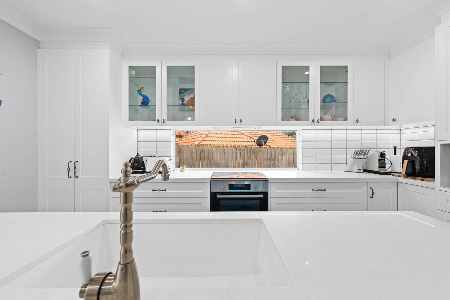 Bright White Modern Kitchen With Cabinets — Above & Beyond Interiors in Smeaton Grange, NSW