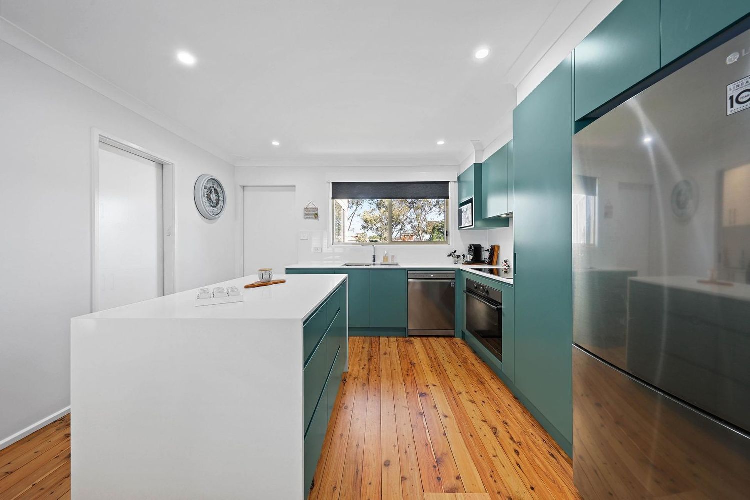 Modern Kitchen With Teal Cabinets, White Island — Above & Beyond Interiors in Smeaton Grange, NSW