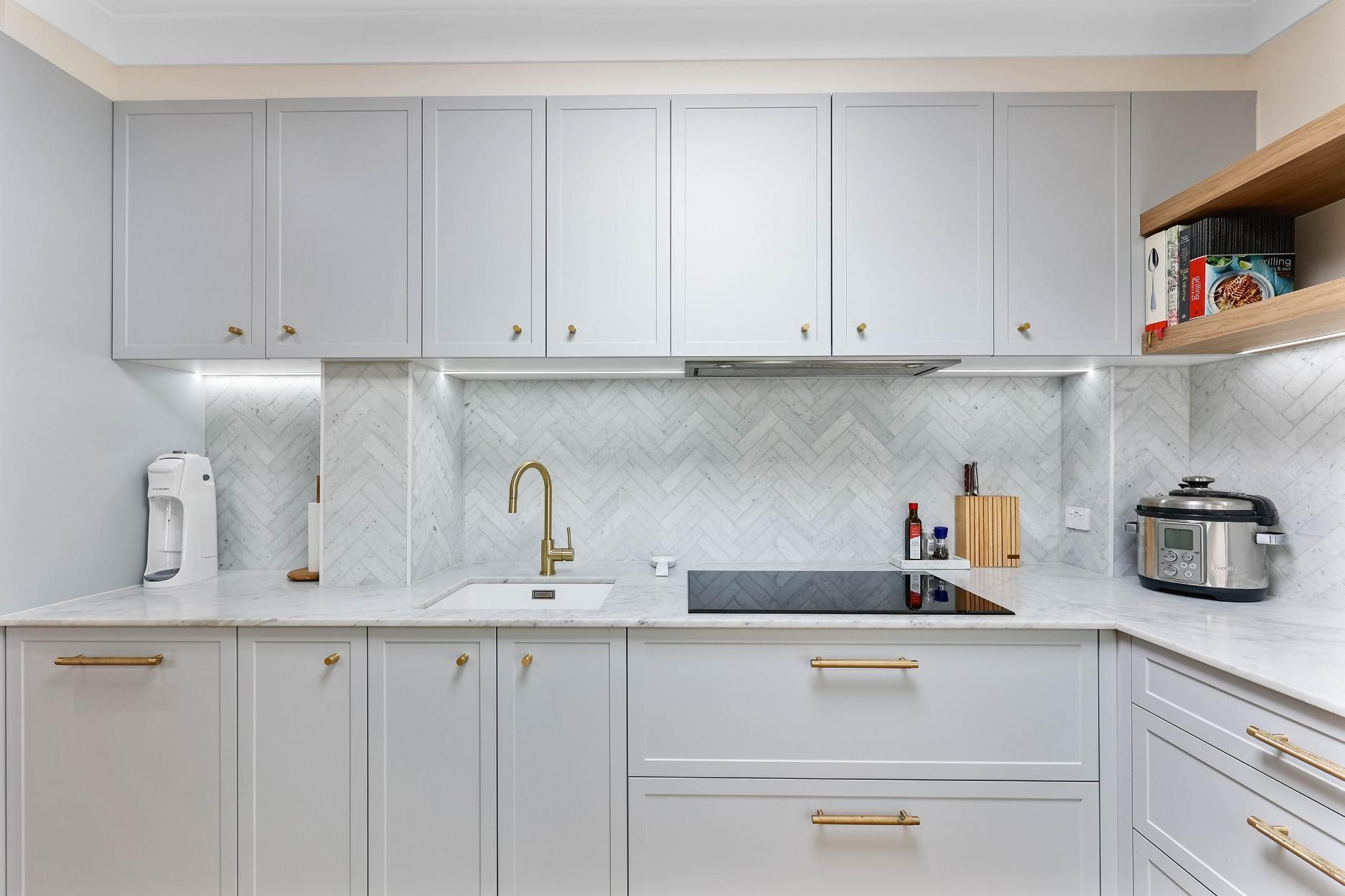 Modern White Kitchen With Gold Hardware — Above & Beyond Interiors in Smeaton Grange, NSW