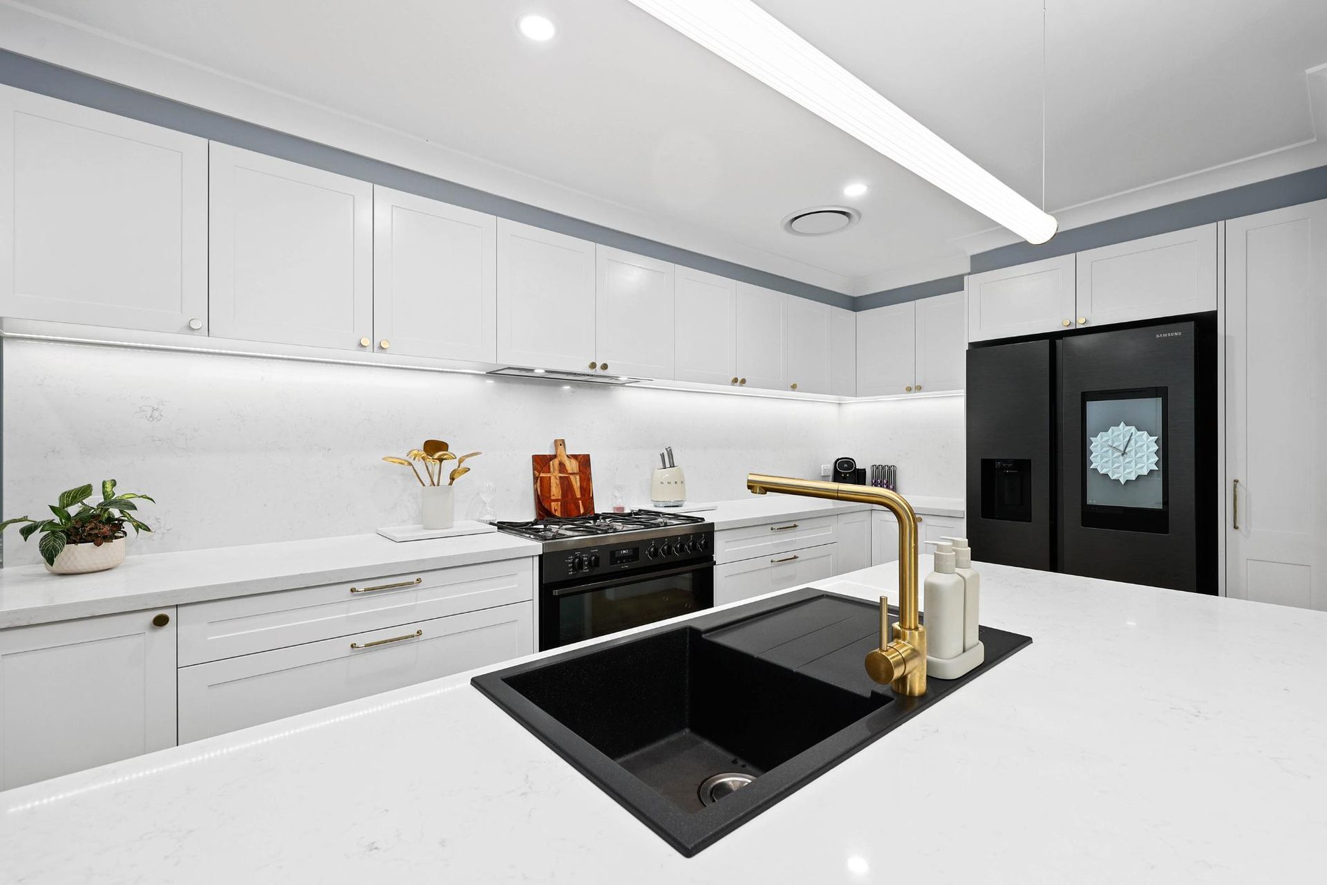 Modern White Kitchen With Black Island Sink — Above & Beyond Interiors in Smeaton Grange, NSW