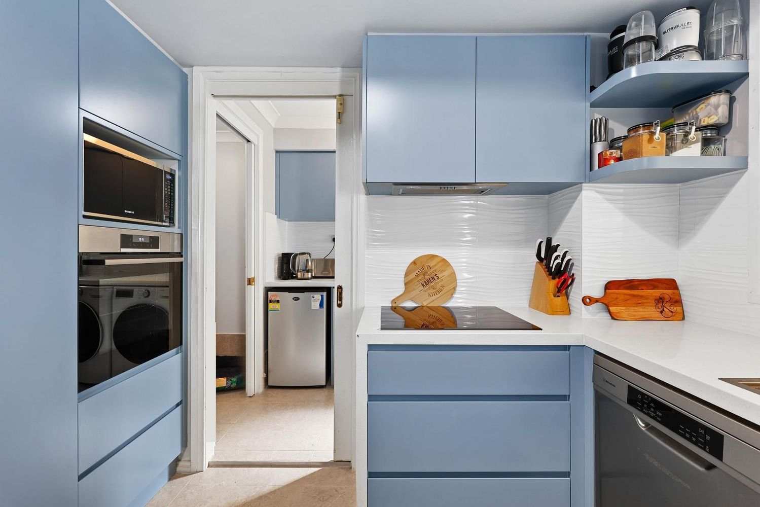Compact Blue-and-white Kitchen With Built-in Oven — Above & Beyond Interiors in Smeaton Grange, NSW