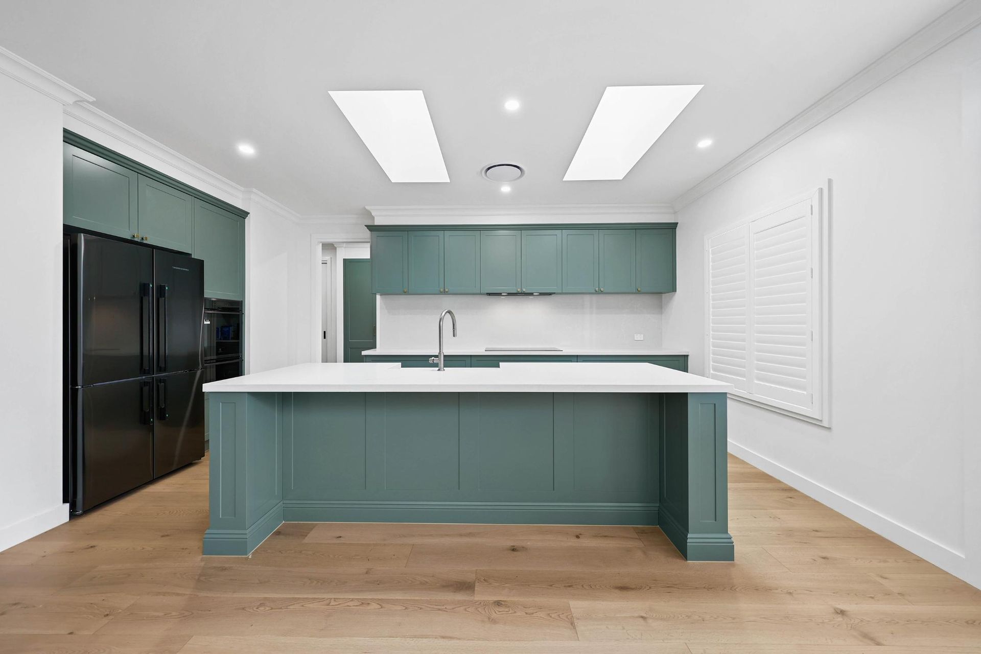 Bright Modern Kitchen With Teal Island — Above & Beyond Interiors in Smeaton Grange, NSW