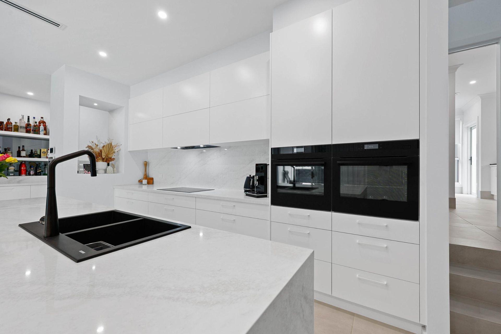 Modern White Kitchen With Black Sink, Countertop — Above & Beyond Interiors in Smeaton Grange, NSW