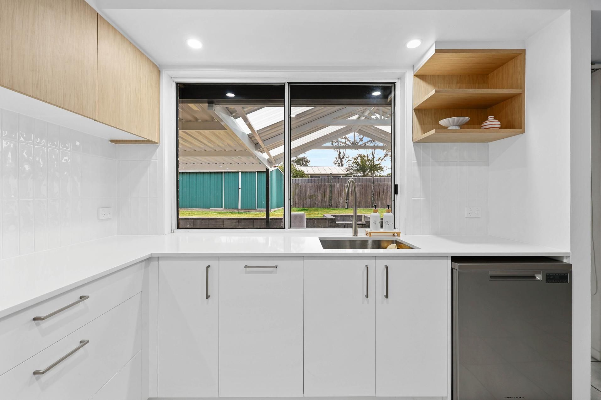 Bright Modern Kitchen With White Cabinets — Above & Beyond Interiors in Smeaton Grange, NSW