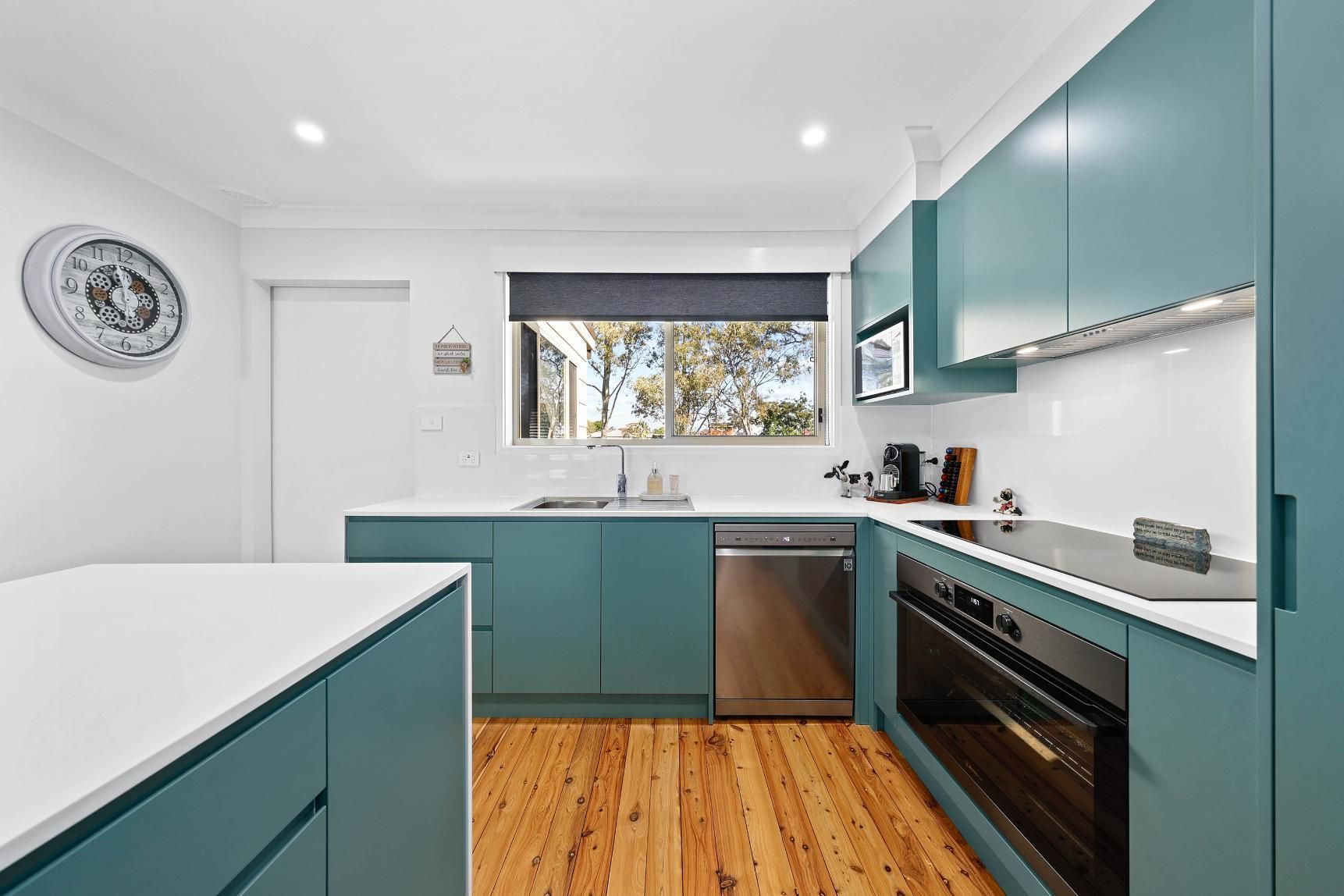 Bright Modern Kitchen With Teal Cabinets — Above & Beyond Interiors in Smeaton Grange, NSW