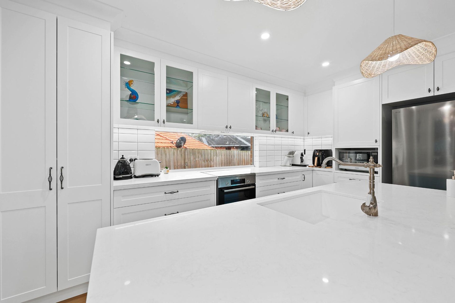 Bright White Modern Kitchen With Marble Island — Above & Beyond Interiors in Smeaton Grange, NSW