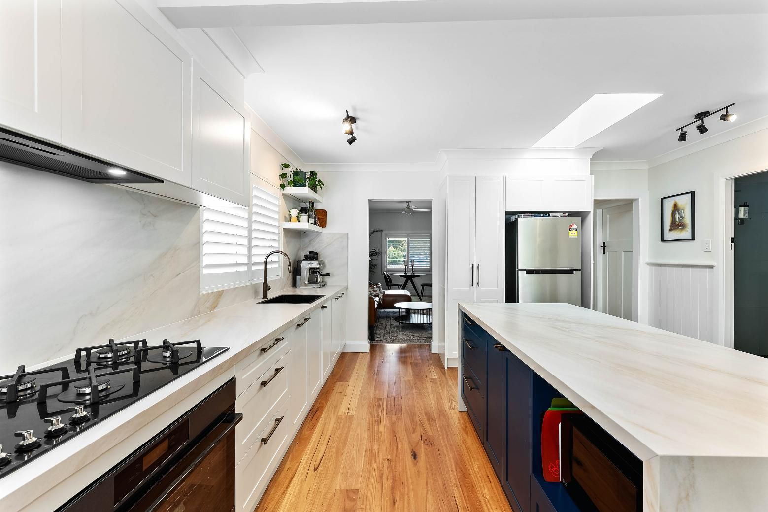 Bright Modern Kitchen With White Cabinets — Above & Beyond Interiors in Smeaton Grange, NSW