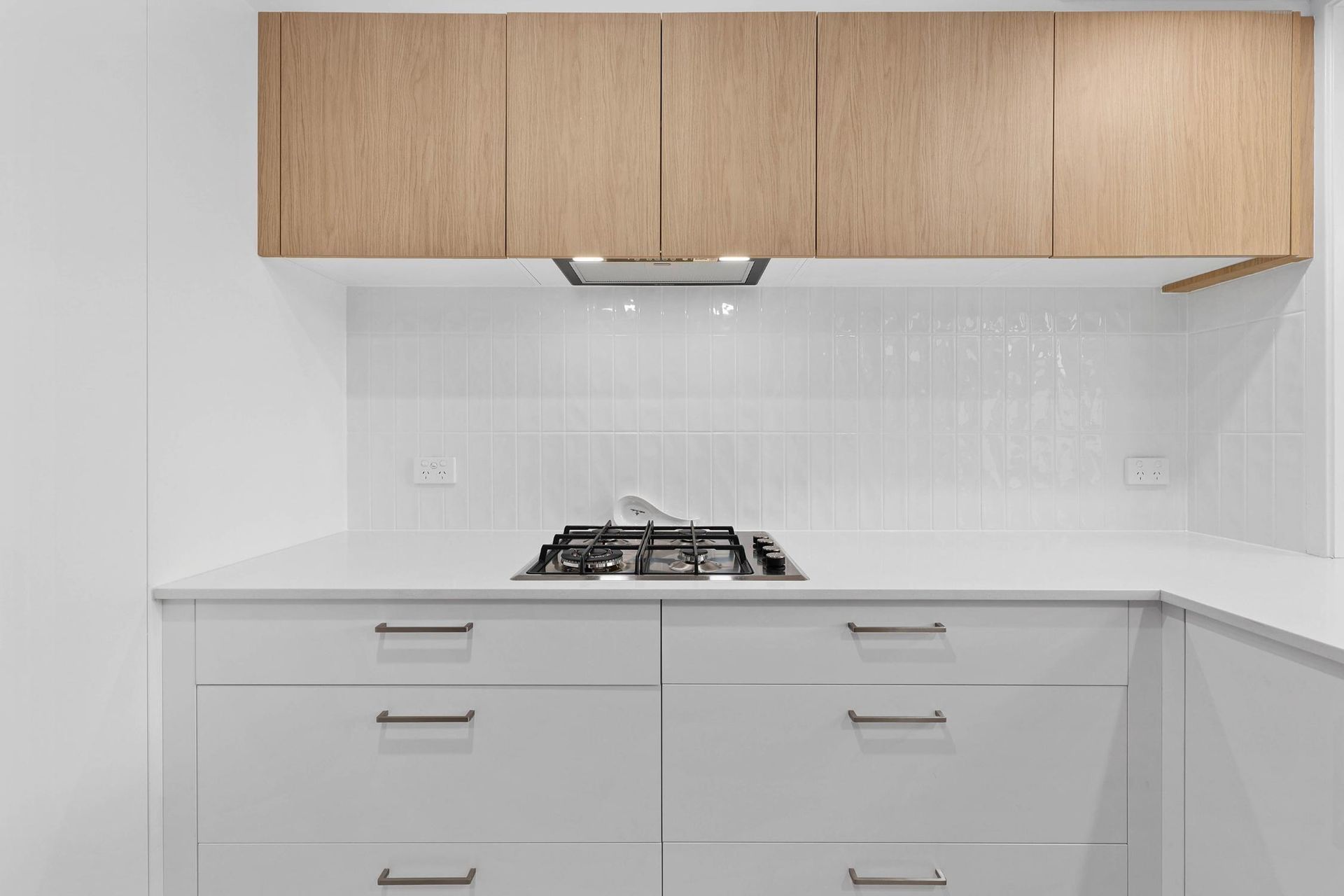 Modern White Kitchen With Wood Cabinets — Above & Beyond Interiors in Smeaton Grange, NSW