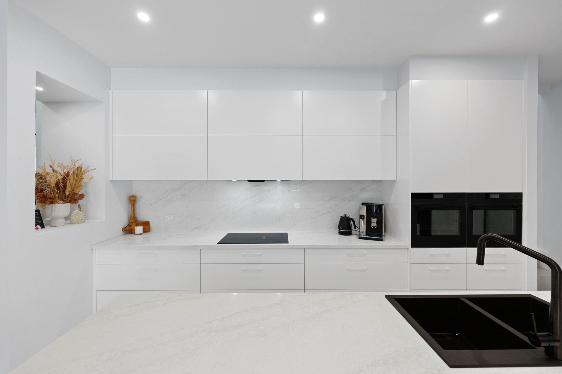 Bright Modern White Kitchen With Marble Counters — Above & Beyond Interiors in Smeaton Grange, NSW