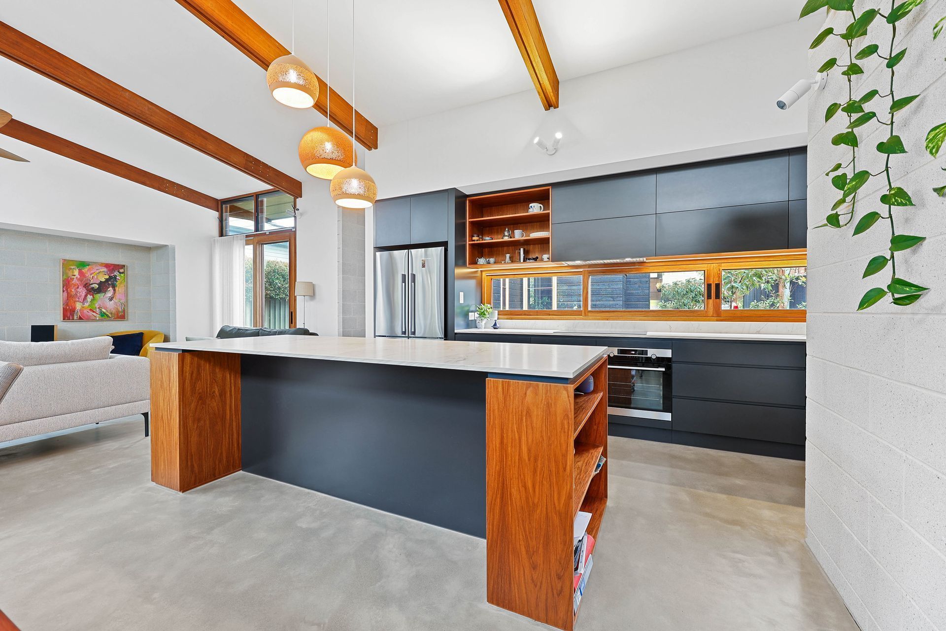 Modern Kitchen With Black Island, Wood Accents — Above & Beyond Interiors in Smeaton Grange, NSW