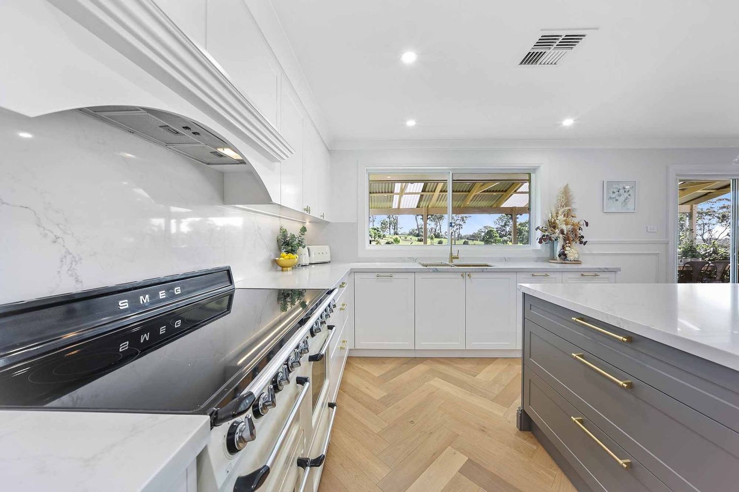 Bright Modern Kitchen With White Cabinets — Above & Beyond Interiors in Smeaton Grange, NSW