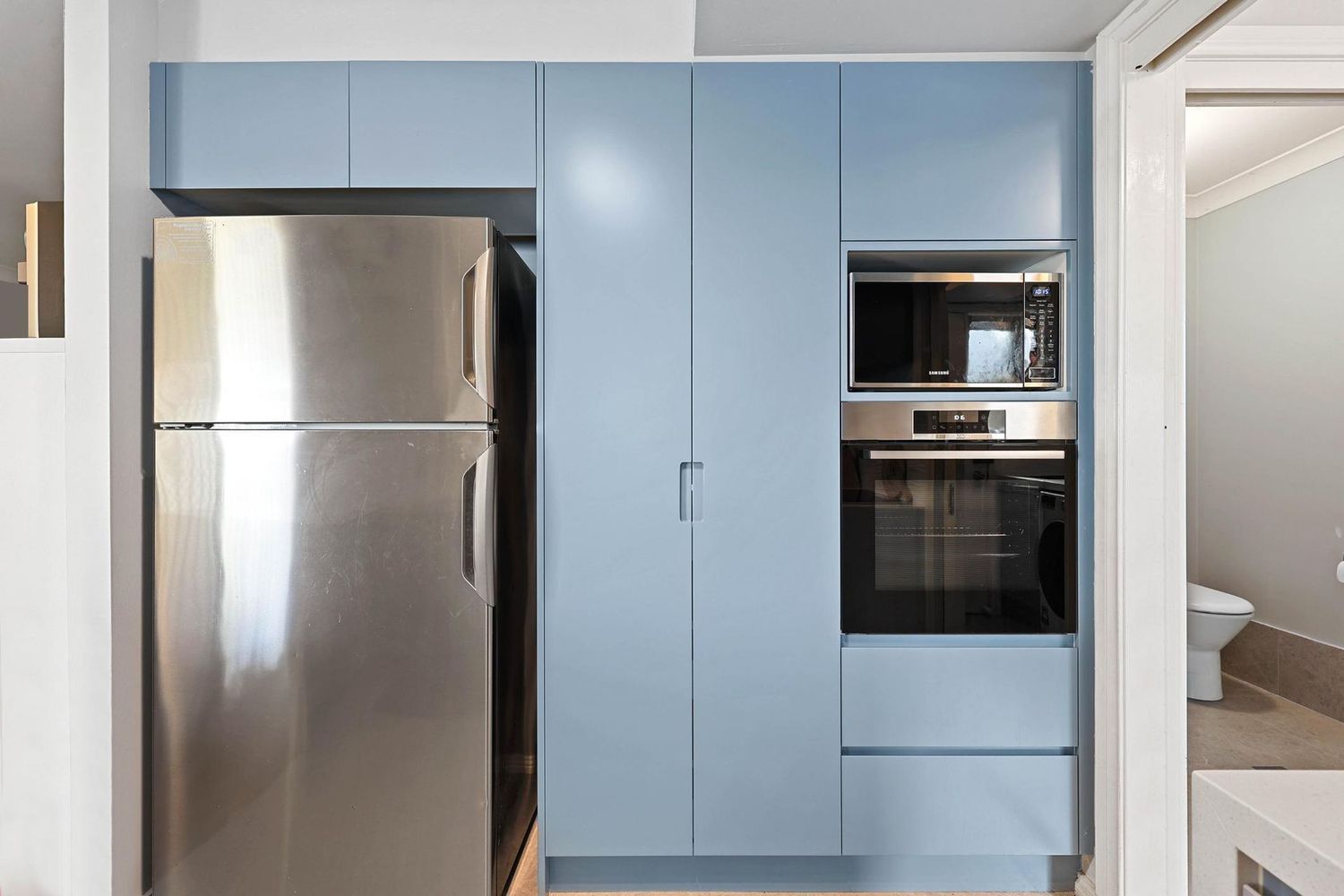 Modern Kitchen With Stainless Steel Fridge — Above & Beyond Interiors in Smeaton Grange, NSW