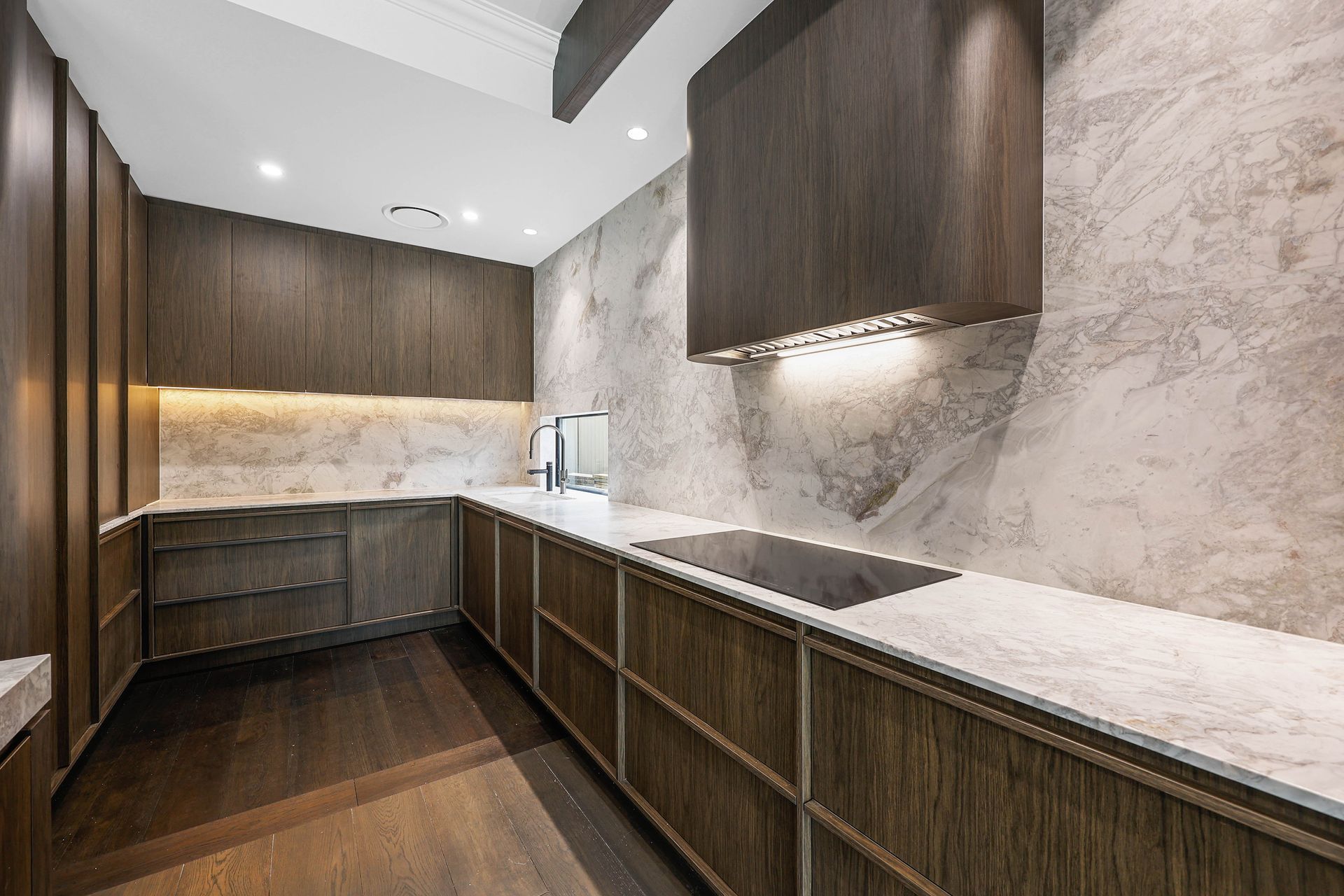 Modern Kitchen With Dark Wood Cabinets — Above & Beyond Interiors in Smeaton Grange, NSW