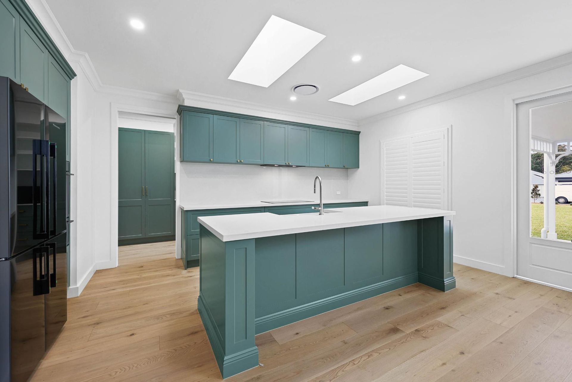 Bright Modern Kitchen With Teal Cabinets — Above & Beyond Interiors in Smeaton Grange, NSW