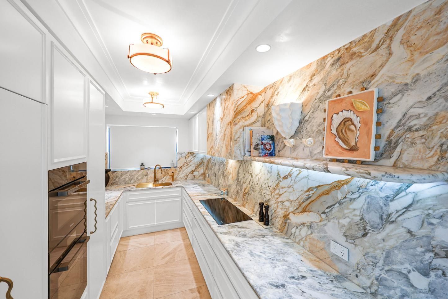 Elegant White Marble Kitchen With Gold Accents — Above & Beyond Interiors in Smeaton Grange, NSW