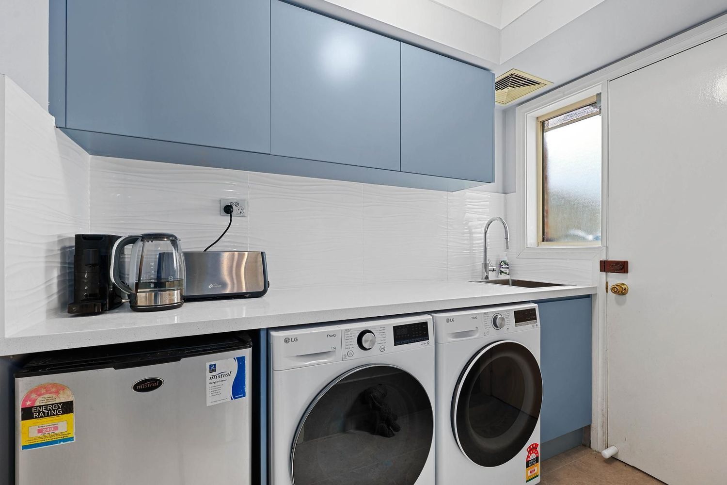 Laundry Room With Washer — Above & Beyond Interiors in Smeaton Grange, NSW
