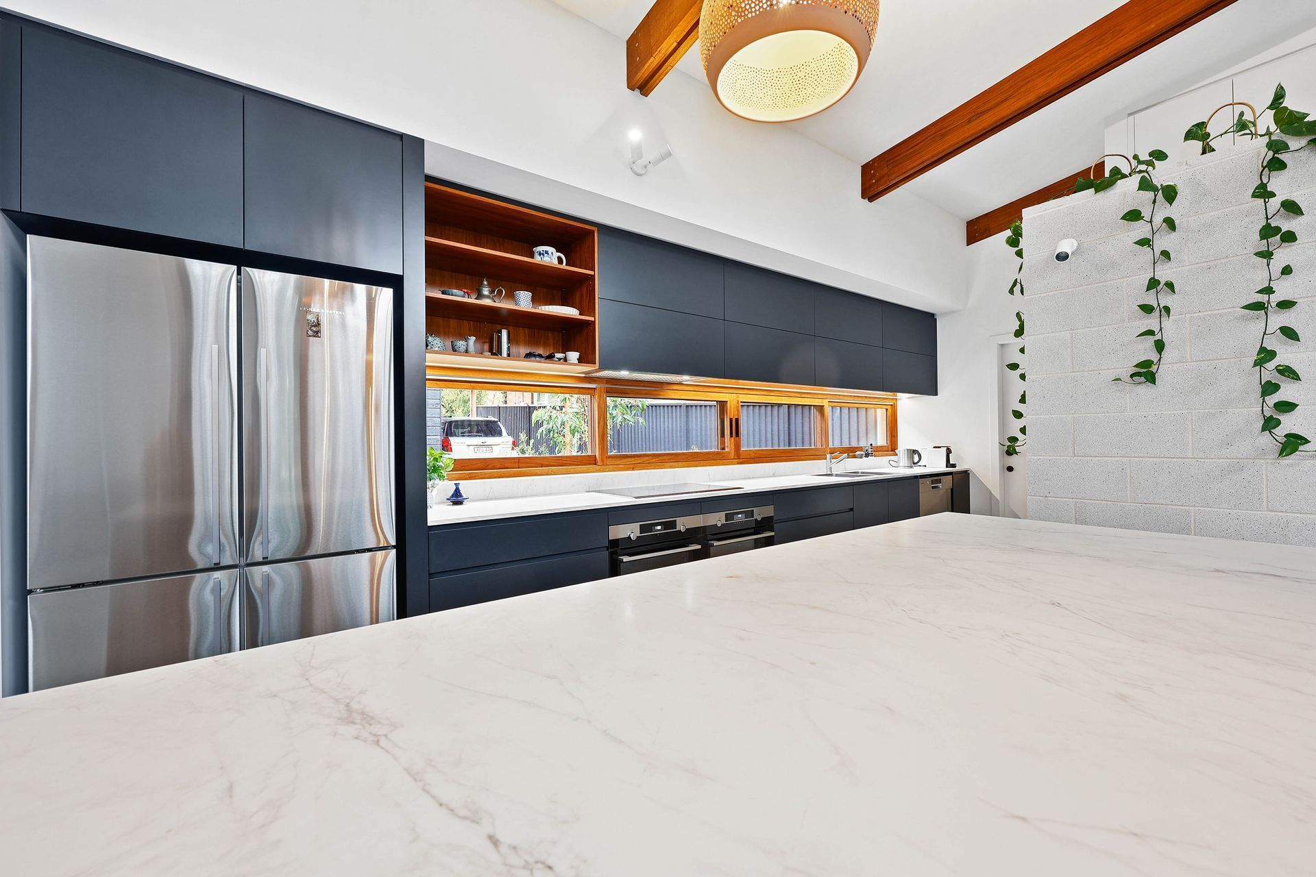 Modern Kitchen With Stainless Steel Fridge — Above & Beyond Interiors in Smeaton Grange, NSW