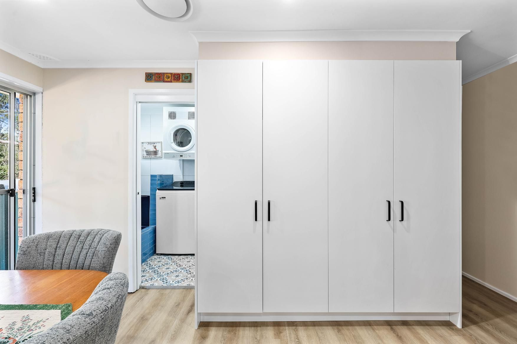 White Wardrobe in a Bright Room With a Doorway — Above & Beyond Interiors in Smeaton Grange, NSW
