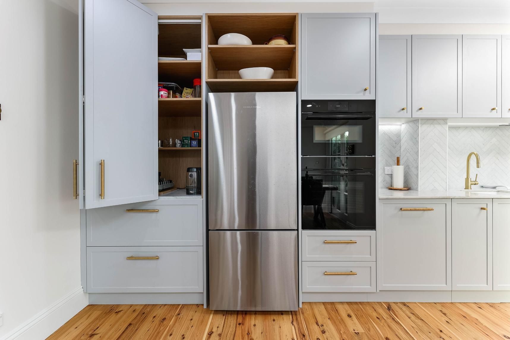 Modern White Kitchen With Stainless Steel Refrigerator — Above & Beyond Interiors in Smeaton Grange, NSW