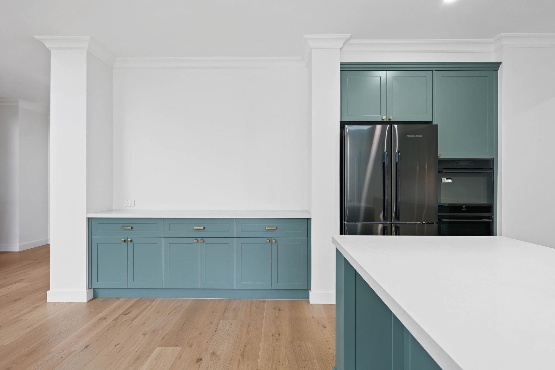 Modern Kitchen With Teal Cabinets, Stainless Steel Fridge — Above & Beyond Interiors in Smeaton Grange, NSW