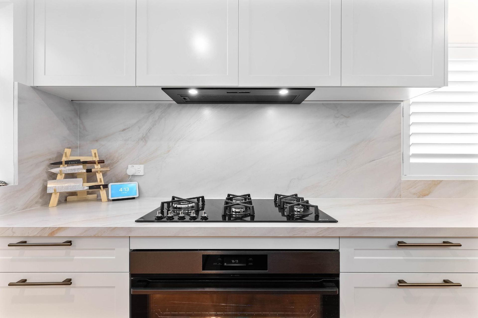 Modern White Kitchen With Marble Backsplash — Above & Beyond Interiors in Smeaton Grange, NSW