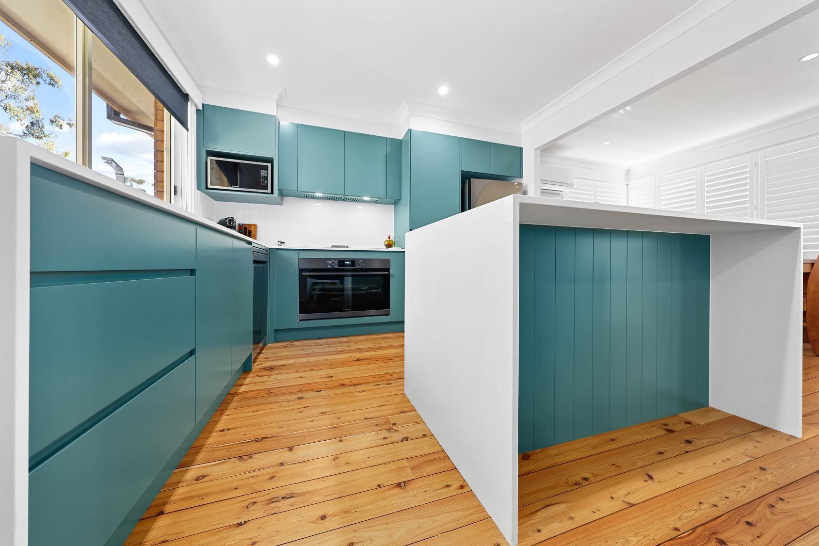 Modern Teal Kitchen With White Island — Above & Beyond Interiors in Smeaton Grange, NSW