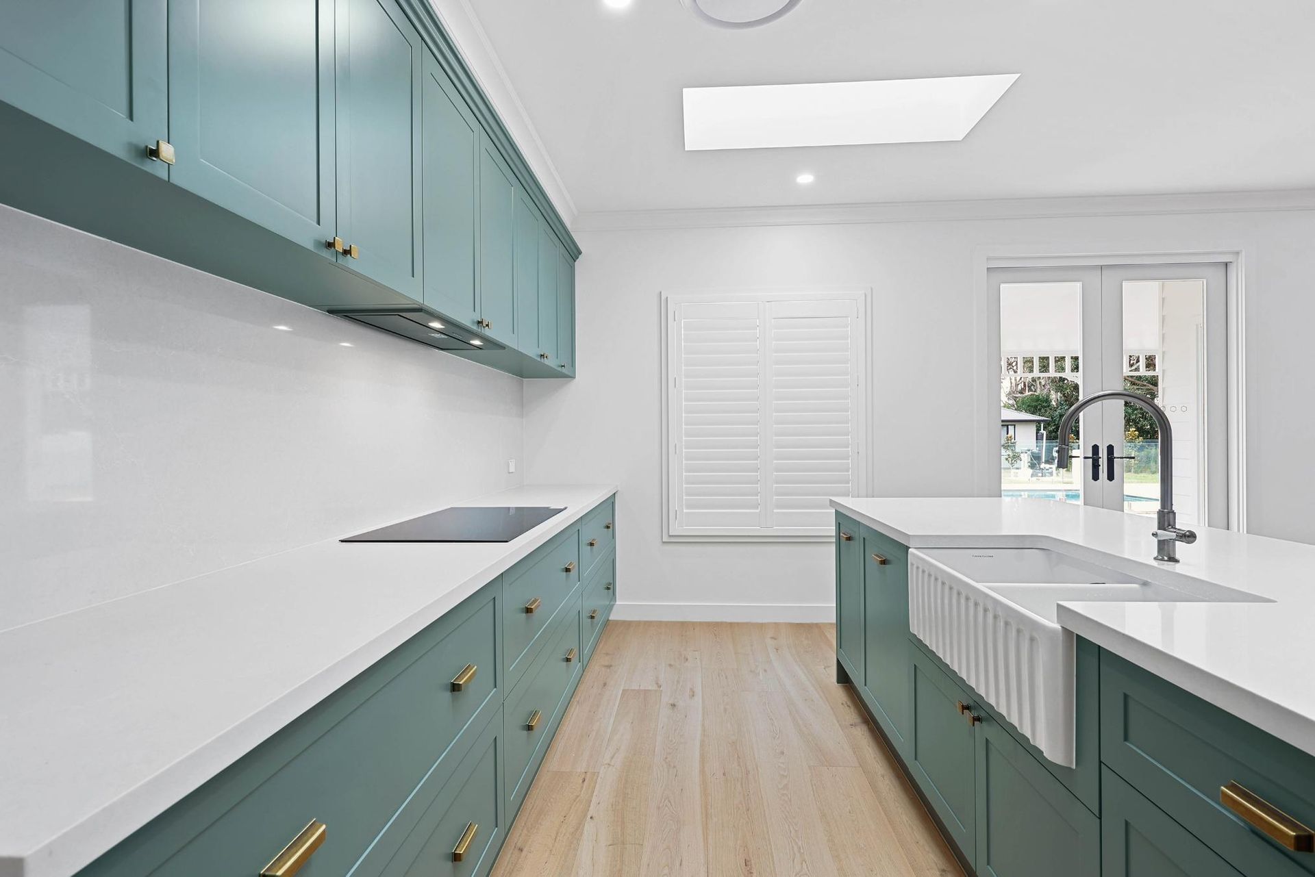 Bright Modern Kitchen With Teal Cabinets — Above & Beyond Interiors in Smeaton Grange, NSW