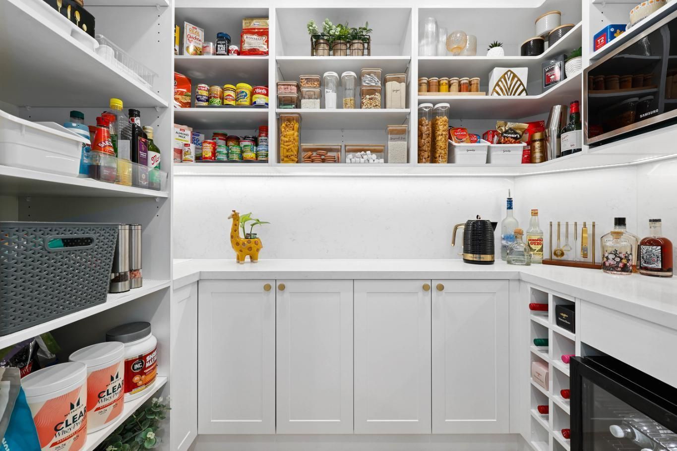 Bright Walk-in Pantry With White Shelves, Glass Jars — Above & Beyond Interiors in Smeaton Grange, NSW